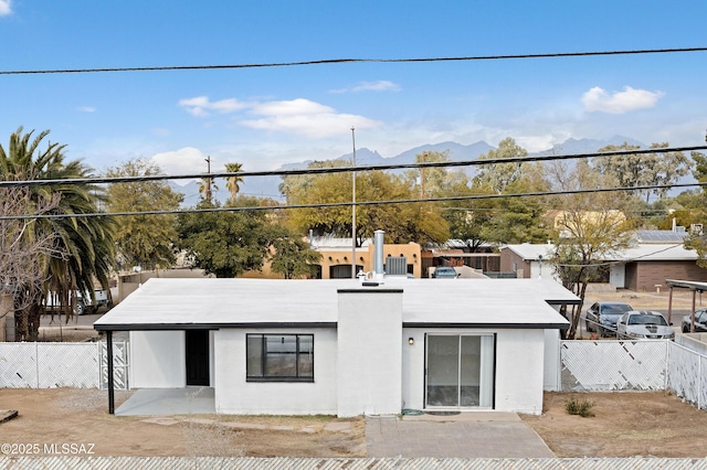 view of front of house with a mountain view and a patio area