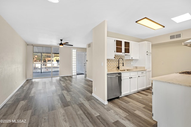 kitchen featuring sink, white cabinets, decorative backsplash, light hardwood / wood-style floors, and stainless steel appliances