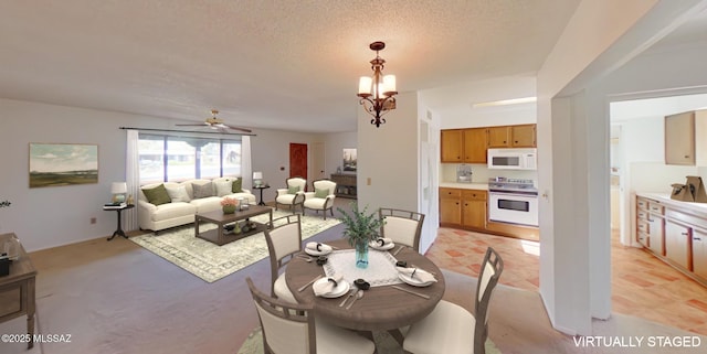 dining area featuring a textured ceiling and a chandelier