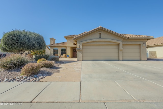 mediterranean / spanish house featuring a garage