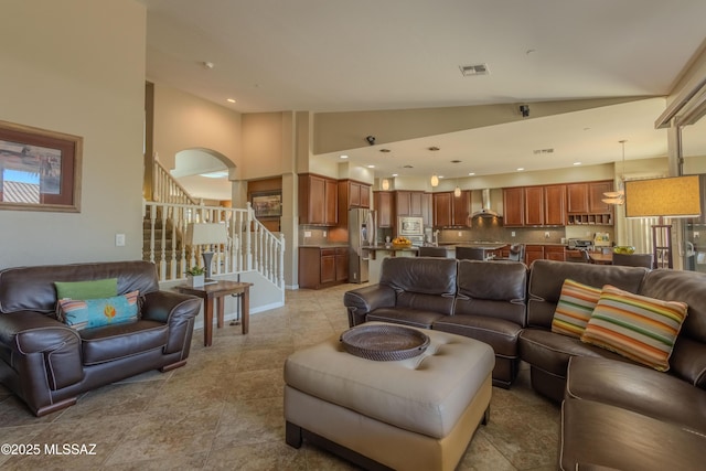 living room featuring high vaulted ceiling