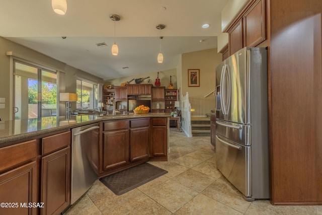 kitchen featuring light tile patterned flooring, lofted ceiling, appliances with stainless steel finishes, and decorative light fixtures