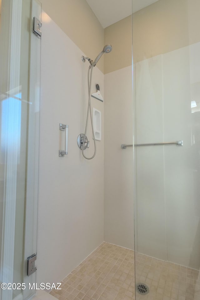 bathroom with a shower with shower door