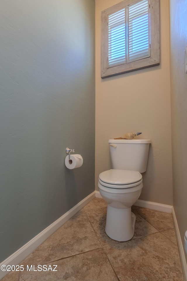 bathroom with tile patterned flooring and toilet