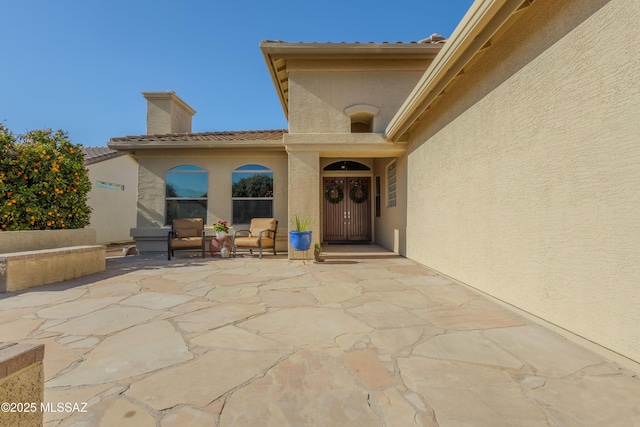 entrance to property with a patio area