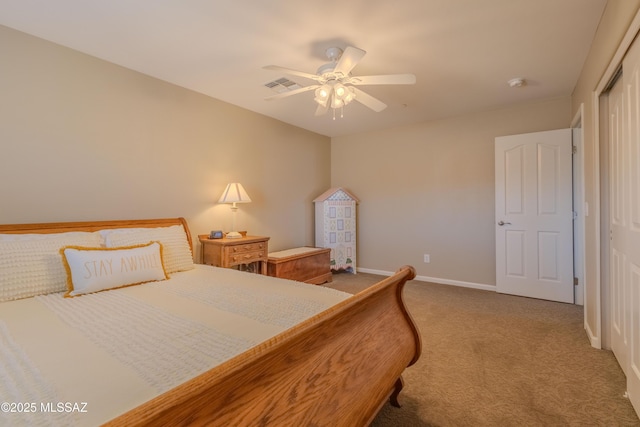 carpeted bedroom featuring ceiling fan and a closet