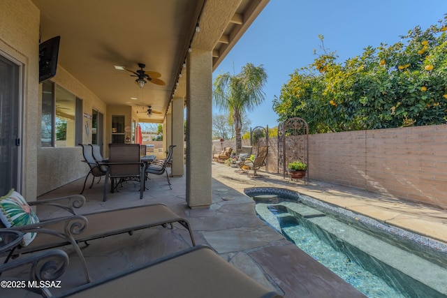 view of patio featuring ceiling fan and a fenced in pool