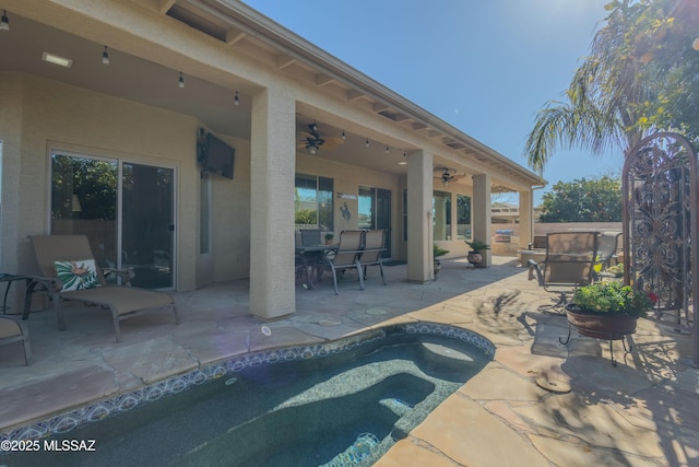 view of pool featuring ceiling fan and a patio area