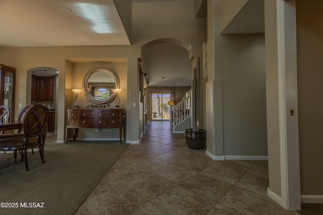 entrance foyer featuring dark carpet