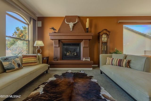 carpeted living room featuring a fireplace