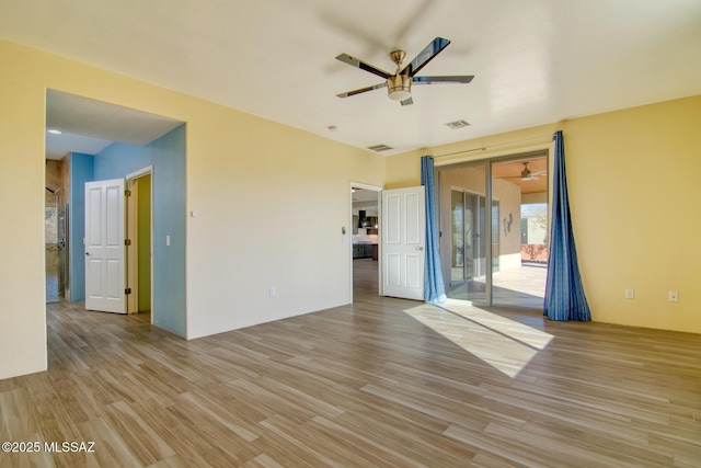 spare room featuring ceiling fan and light hardwood / wood-style floors