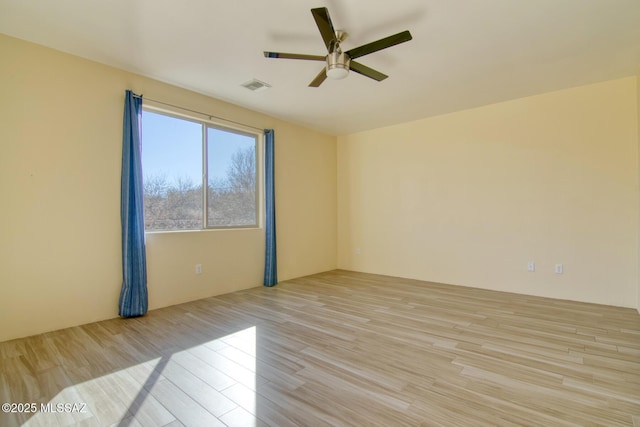 spare room featuring ceiling fan and light hardwood / wood-style floors