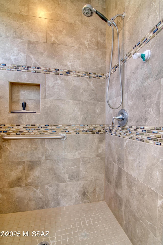 bathroom with tiled shower