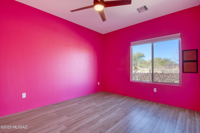 spare room featuring ceiling fan and light hardwood / wood-style flooring