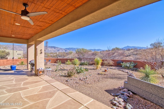 view of patio featuring a mountain view and ceiling fan