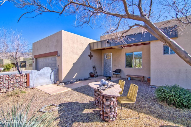 pueblo-style house with a garage