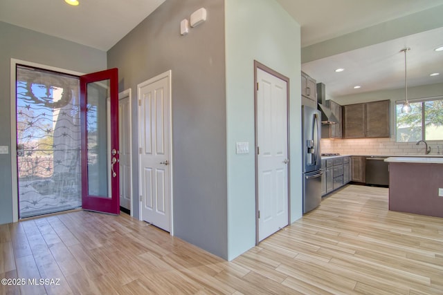 entrance foyer with sink and light hardwood / wood-style floors