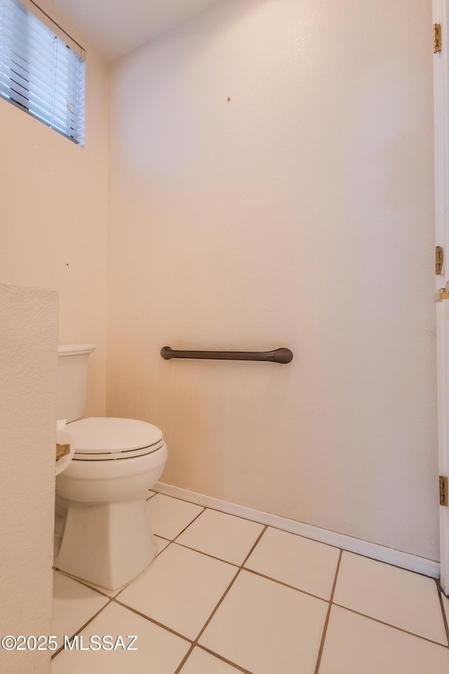 bathroom with tile patterned floors and toilet