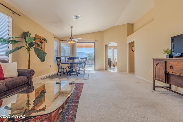 carpeted living room with lofted ceiling