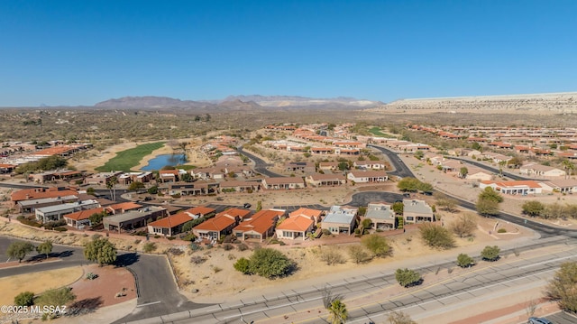 birds eye view of property with a water and mountain view