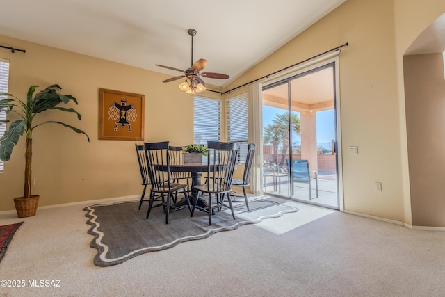 dining area featuring ceiling fan, lofted ceiling, and carpet flooring