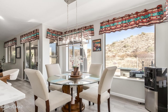 dining area with a mountain view and light wood-type flooring