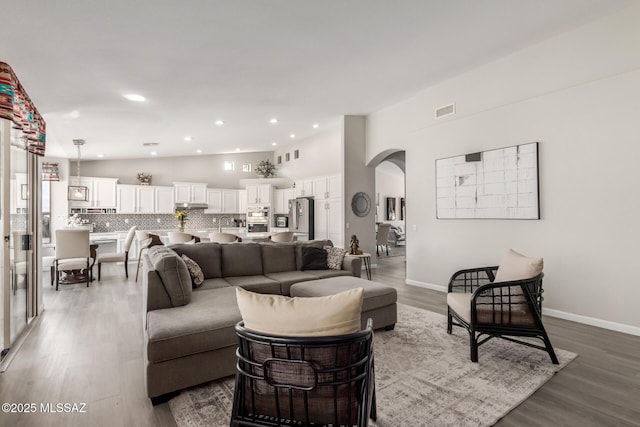 living room featuring hardwood / wood-style flooring and vaulted ceiling