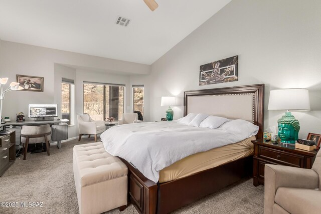 carpeted bedroom featuring ceiling fan and high vaulted ceiling