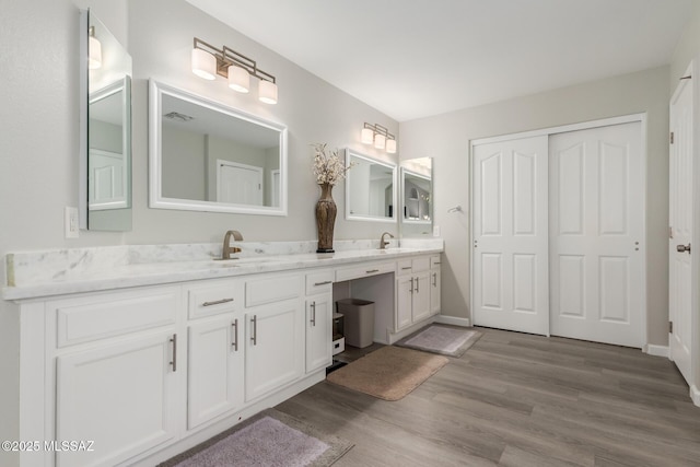 bathroom featuring hardwood / wood-style flooring and vanity