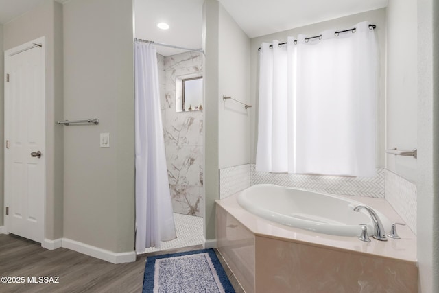 bathroom featuring plus walk in shower and hardwood / wood-style floors