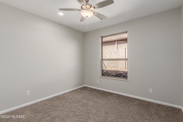 carpeted empty room featuring ceiling fan