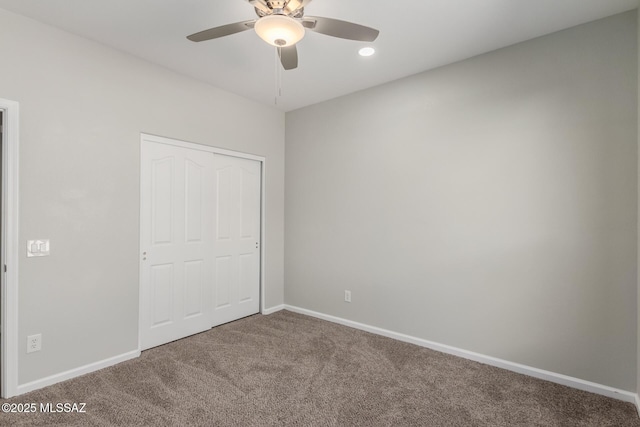 unfurnished bedroom featuring carpet floors, ceiling fan, and a closet