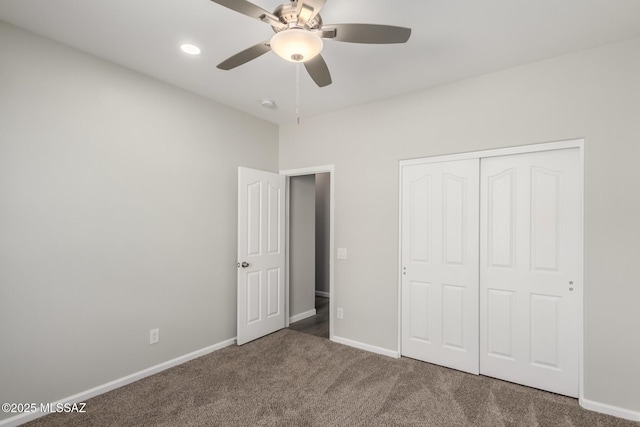 unfurnished bedroom with dark colored carpet, ceiling fan, and a closet