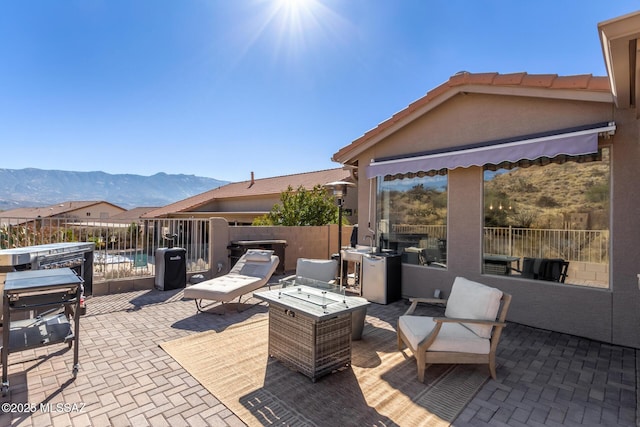 view of patio featuring a mountain view and an outdoor fire pit