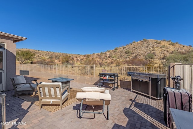 view of patio with a mountain view and grilling area