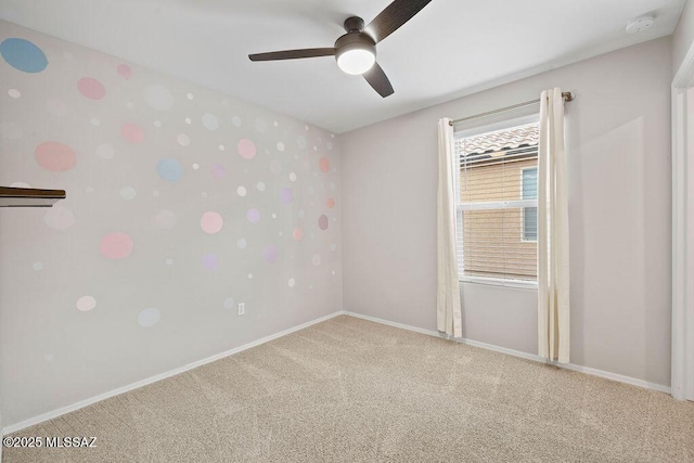 unfurnished room featuring ceiling fan and carpet flooring