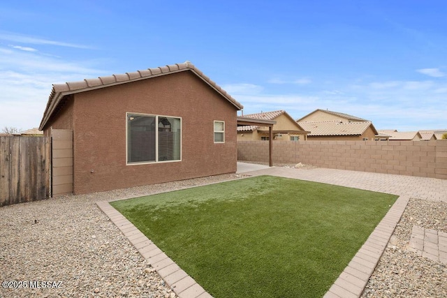 rear view of property featuring a patio area