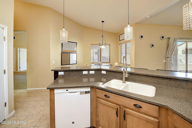 kitchen with lofted ceiling, sink, hanging light fixtures, light tile patterned floors, and white dishwasher