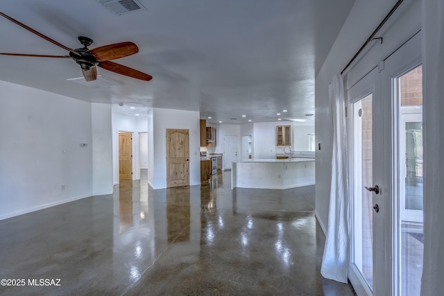 unfurnished living room with sink and ceiling fan