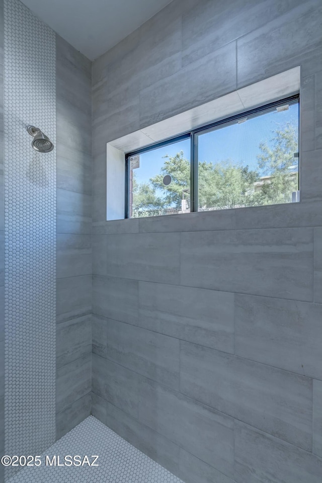 bathroom with tiled shower