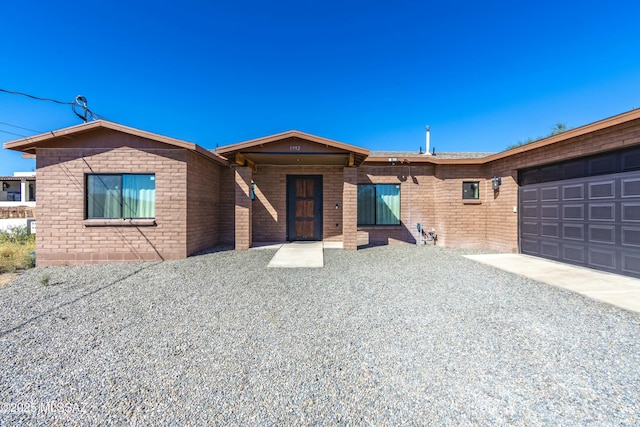 ranch-style home featuring a garage