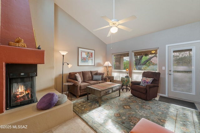 living area with high vaulted ceiling, a fireplace, and a ceiling fan