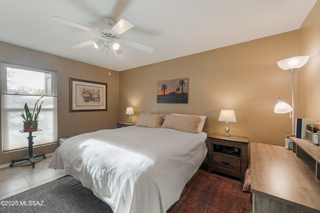 bedroom featuring ceiling fan and tile patterned floors