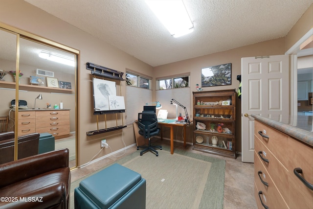 office with visible vents and a textured ceiling