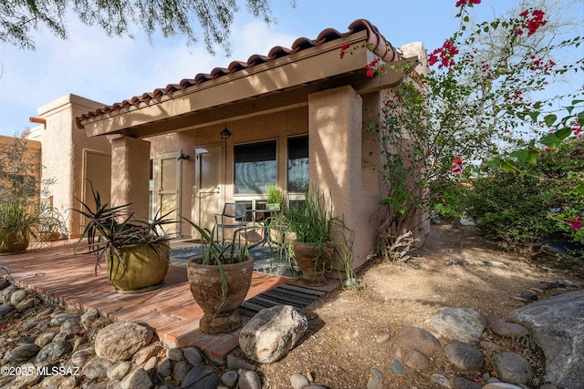 property entrance with stucco siding