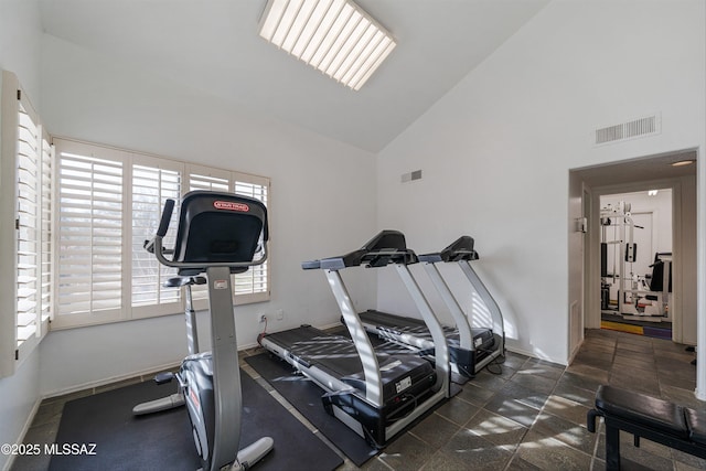 workout room with high vaulted ceiling, visible vents, and baseboards