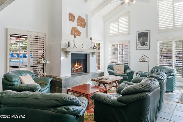 living room featuring a warm lit fireplace, tile patterned flooring, high vaulted ceiling, and beam ceiling