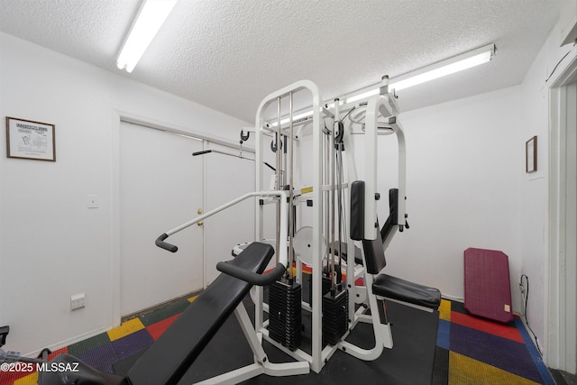 exercise area featuring a textured ceiling