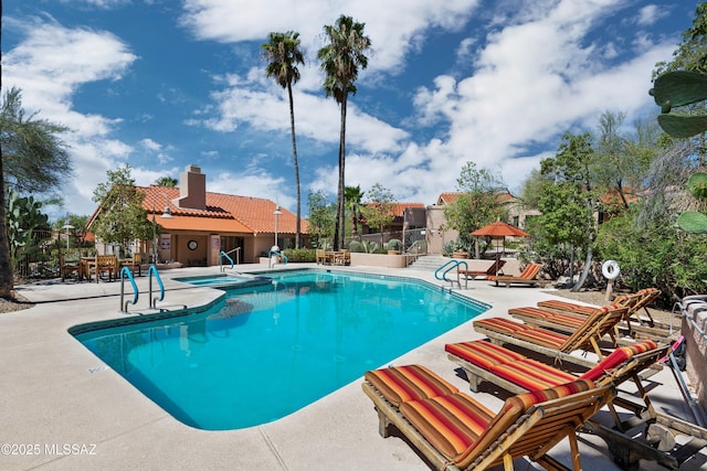 pool featuring a patio area and fence