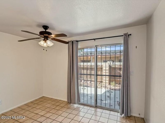 tiled spare room with ceiling fan and a textured ceiling